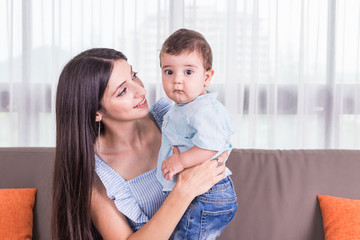 Mother playing with her son. Good health baby smiling. Caucasian kid and Happy family concept