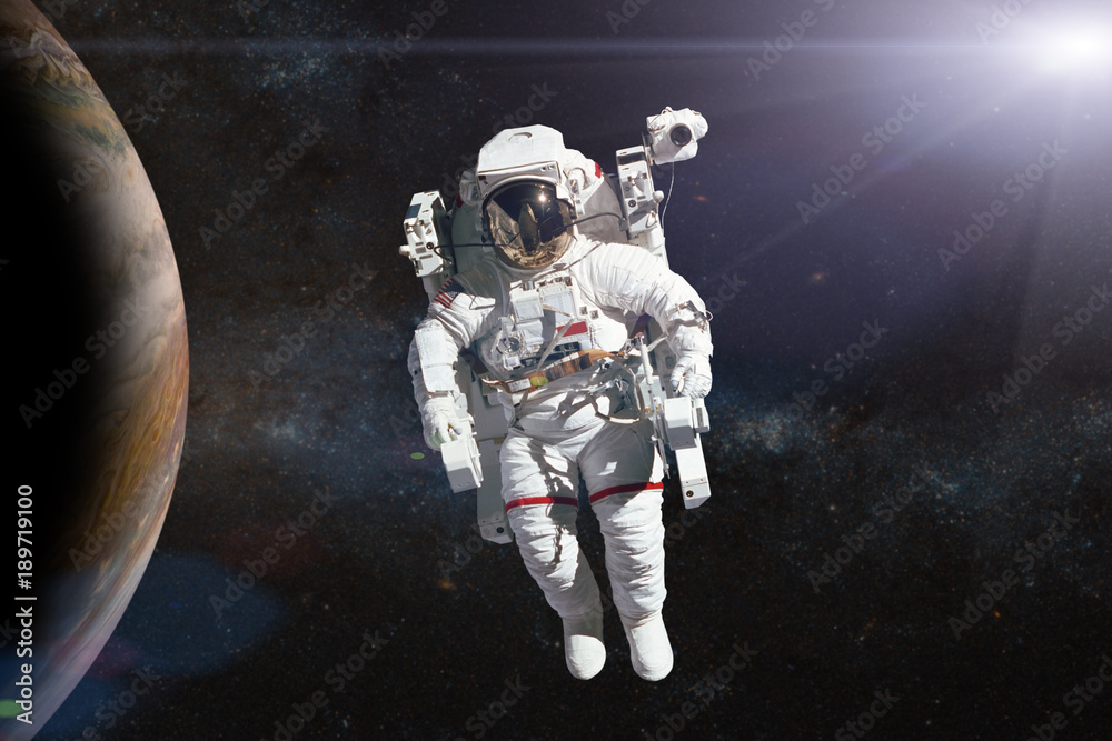 Wall mural astronaut in outer space on background of the planet. elements of this image furnished by nasa.