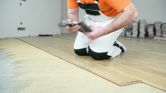 carpenter worker joining parket floor