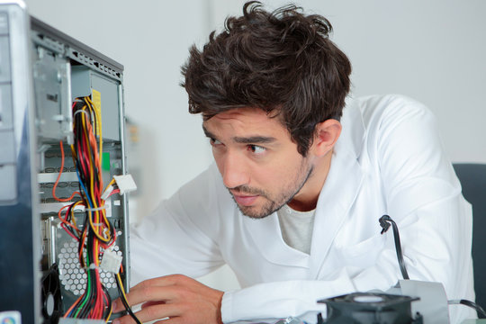 Computer repairman looking confused