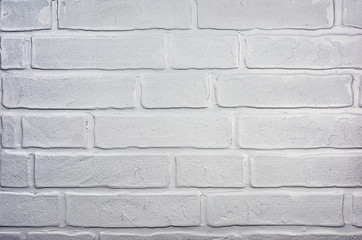 Light gray grunge textured brick wall