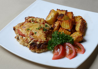 Chopped beef with fresh vegetables on a plate.