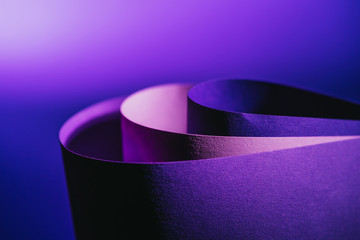 close up view of arcs of purple and pink paper on purple