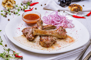 Rack of lamb on a white plate