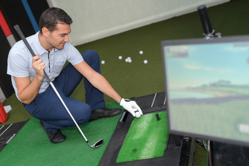 young man playing virutal golf