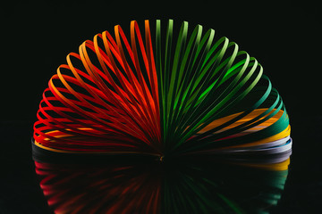 colored quilling paper curves on black