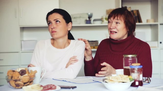 Portrait upset female looking away after conflict, mother talking at home interior