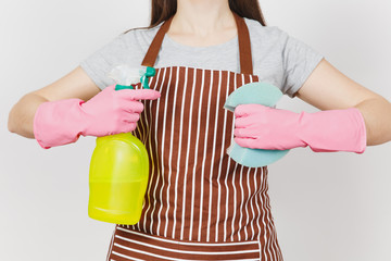 Close up cropped portrait housewife in pink gloves, striped apron isolated on white background. Woman holding yellow spray bottle with cleaner liquid for cleaning sponge. Copy space for advertisement.