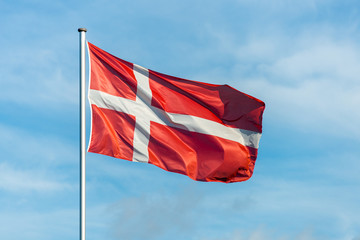 Danish flag waggling in the wind with sky in background - 189723964