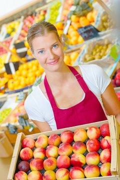 girl holding basketful of apples
