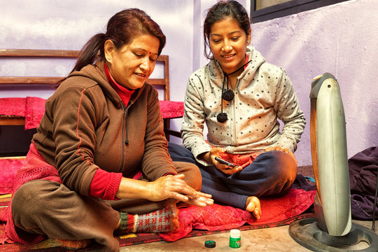 Mother and Daughter in front of Heater, Nepal