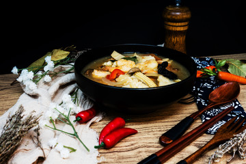 Bowls of Asian soup noodles and vegetables with Chopstick