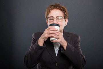 Business senior lady enjoying takeaway cup of coffee