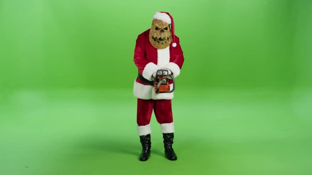 Bad angry Santa Claus killer threatening with a chainsaw
