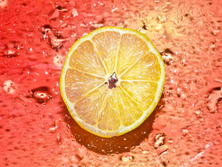 .Cross-section of the juicy lemon on red  background .