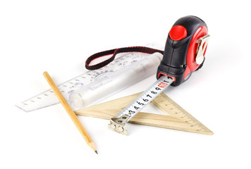Tape measure, pencil and ruler on a white background. Closeup