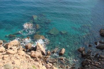 an amazing combination of shades of blue water of the Aegean coast near the shore.