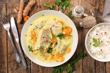 fish cooked with cream, carrot and curcuma