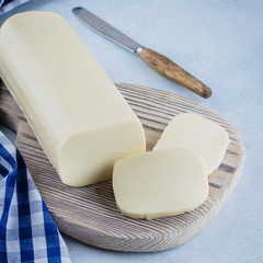 White mozzarella on blue concrete stone background table. Healthy Food Concept. Daily product. Copy...