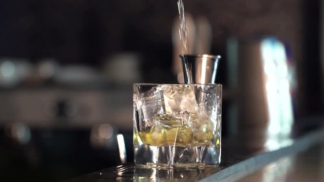 The barman makes a cocktail