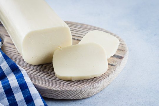 White mozzarella on blue concrete stone background table. Healthy Food Concept. Daily product. Copy space