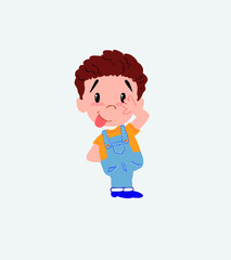 White boy in jeans sticks out his tongue in gesture of funny shyness.