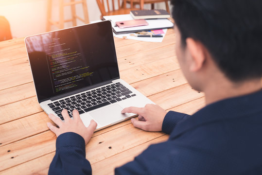 The abstract image of the asian programer developing the software by the desktop computer. The concept of coding, programing, developing, software, education and technology.