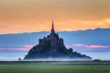 Beautiful panoramic view of famous Le Mont Saint-Michel tidal island at sunrise. Normandy, northern...