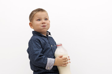 Smiling child boy drinking milk