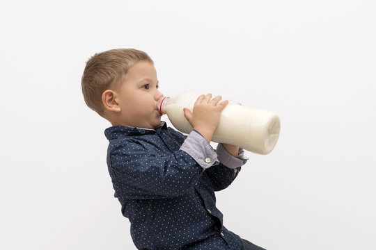 Smiling child boy drinking milk
