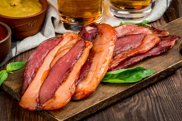Smoked meat cut into pieces on the background