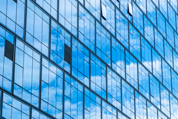 Naklejka na ściany i meble Clouds Reflected in Windows of Modern Office Building.