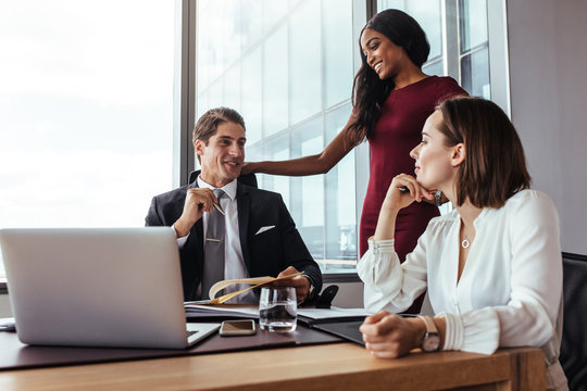 Businessman working with female colleagues in office