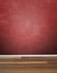 Red textured wall and hardwood floor