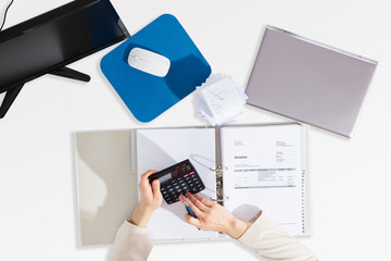 Businessperson Calculating Invoice