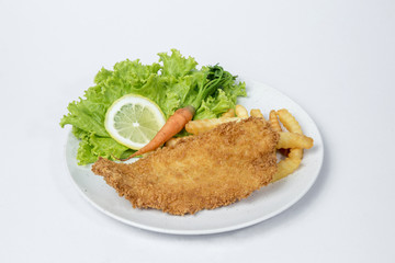 Fish and chips served with  salad and lemon