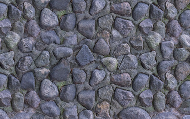 panne light gray dark stones stacked wall of old dried fountain weathered textured closeup background old masonry