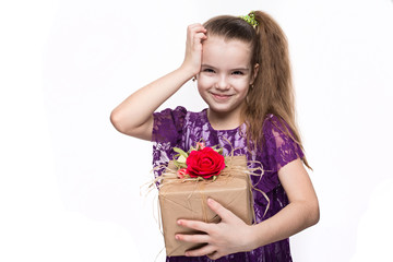 Beautiful caucasian girl in purple lace dress holding a box with a gift decorated with flowers. Shooting in studio on isolated white background