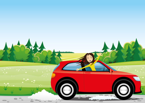 Cheerful woman in a red car on a road in the field.