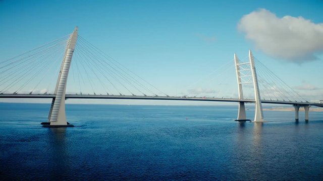 Car traffic on cable stayed bridge with view on urban infrastructure in developed cit