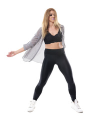 Active young sporty aerobics jazz dance instructor dancing and moving arms. Full body length portrait isolated on white studio background. 