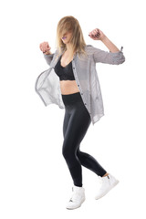 Energetic female jazz dancer dancing with blonde tousled hair flowing over face. Full body length portrait isolated on white studio background. 