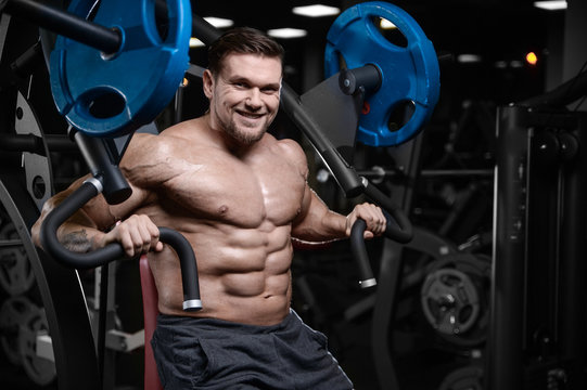 Brutal strong bodybuilder athletic men pumping up muscles with dumbbells.