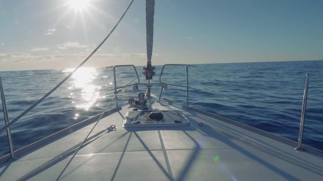 View of sea and path of sparkles from yacht board sailing to west after midday
