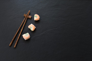 Space Vietnamese food spring rolls with chopsticks


