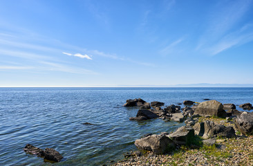 Fototapeta na wymiar Dark boulders on shore of Lake Baikal