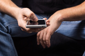 Close up hand sending message with phone with copy space
