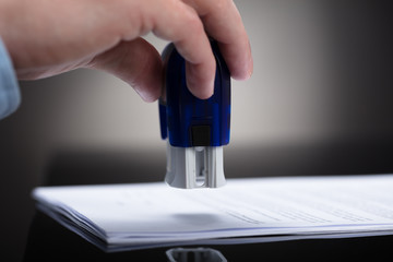Businessperson Stamping On Approved Contract Form