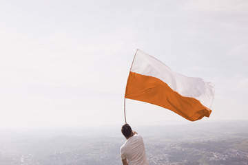 Men with a orange and white flag