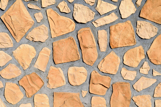 Texture, Surface of wall made of cement and yellow stone